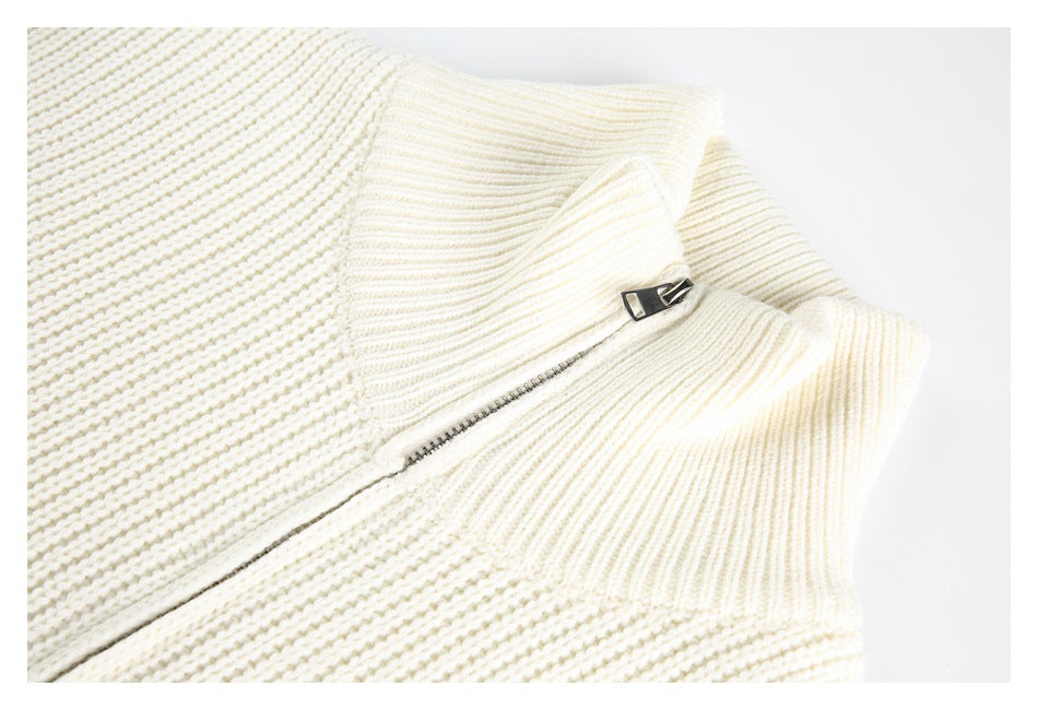 Close-up of a cream rib-knit collar and partially visible metal zipper.