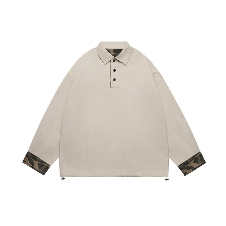 Khaki long-sleeve polo-collar pullover with three buttons, camouflage cuffs and hem drawcord toggles, flat lay