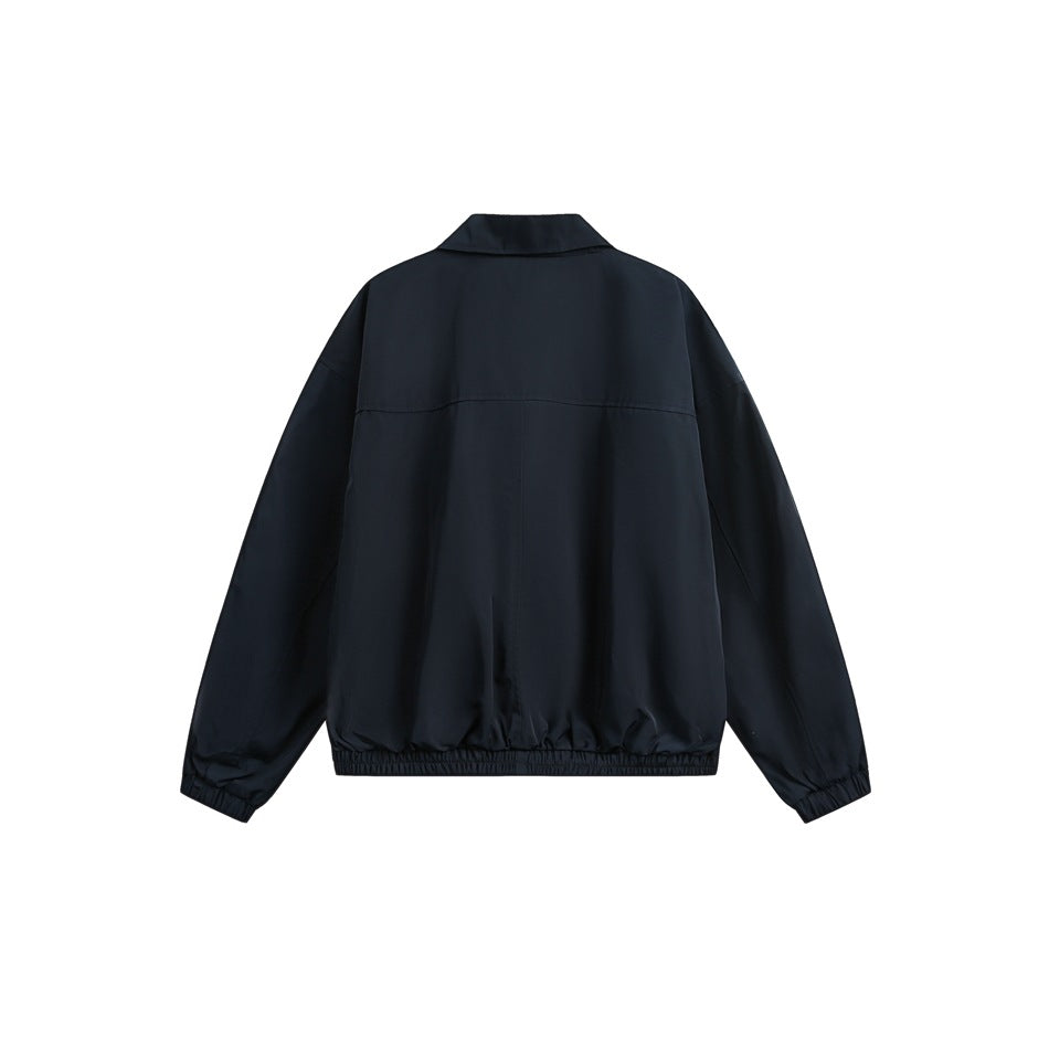 Back view of a dark navy jacket with a pointed collar, long sleeves, and elasticated cuffs and hem.