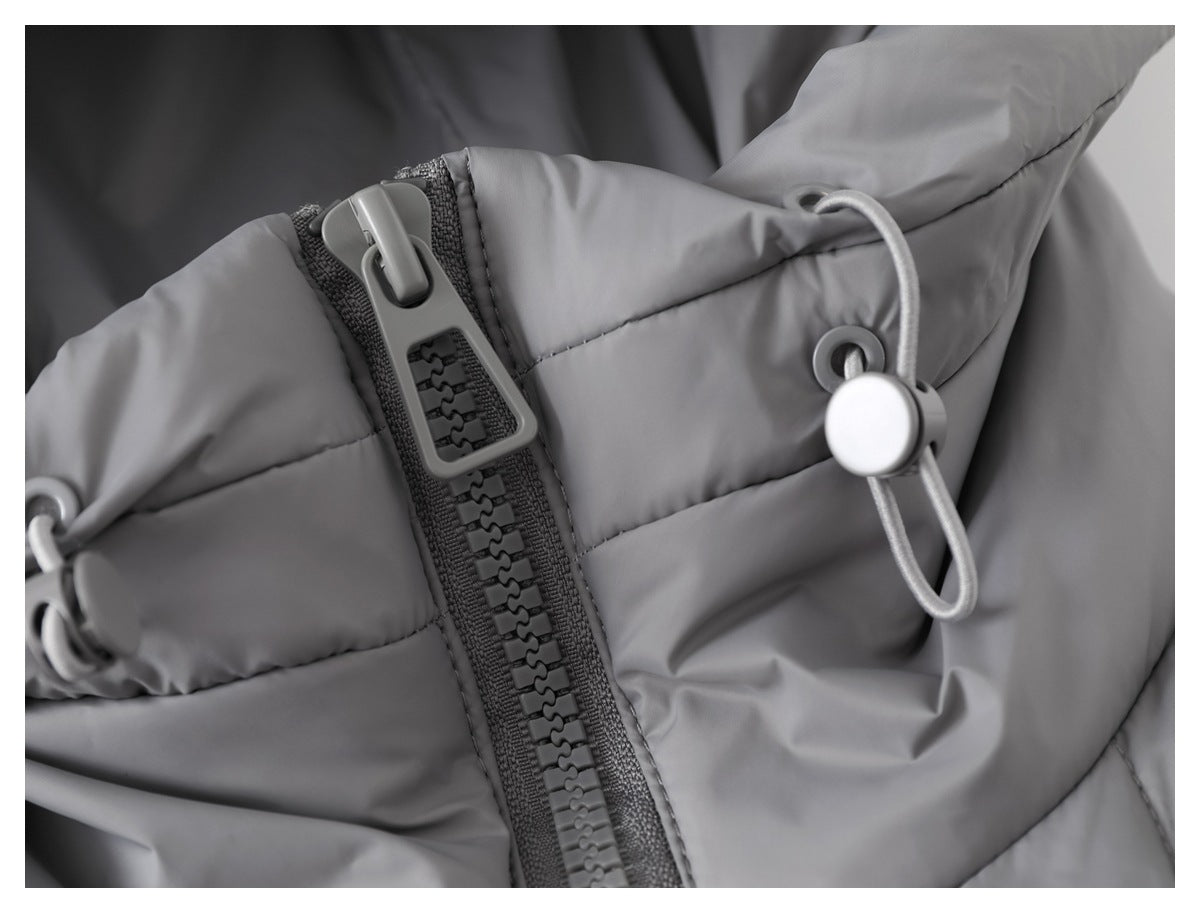 Close-up of a gray padded jacket showing a chunky zipper and an adjustable hood drawcord toggle.
