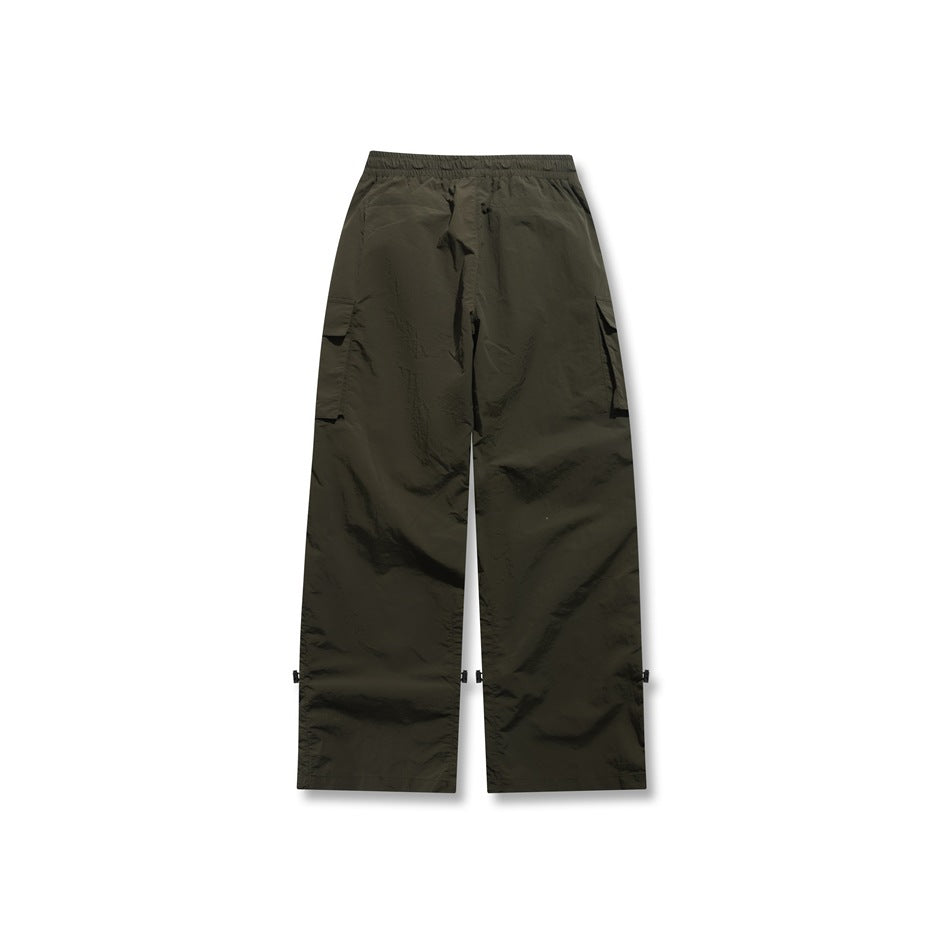Back view of dark olive wide-leg cargo pants with an elastic waistband and side cargo pockets.