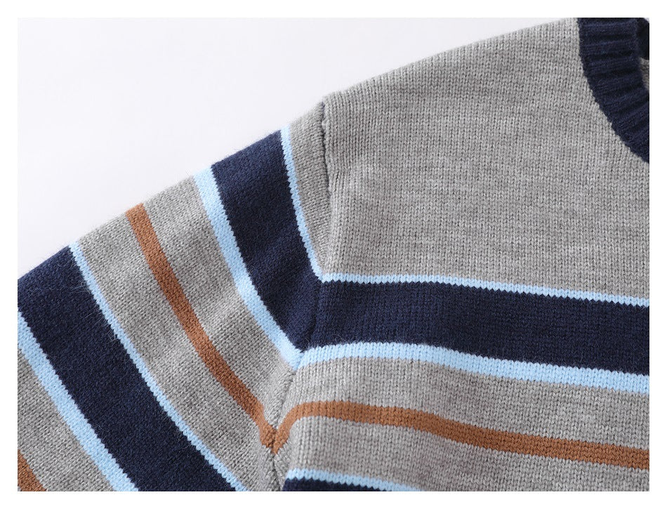 Close-up of a gray striped knit sweater showing the shoulder seam and navy, pale blue, and rust stripes.