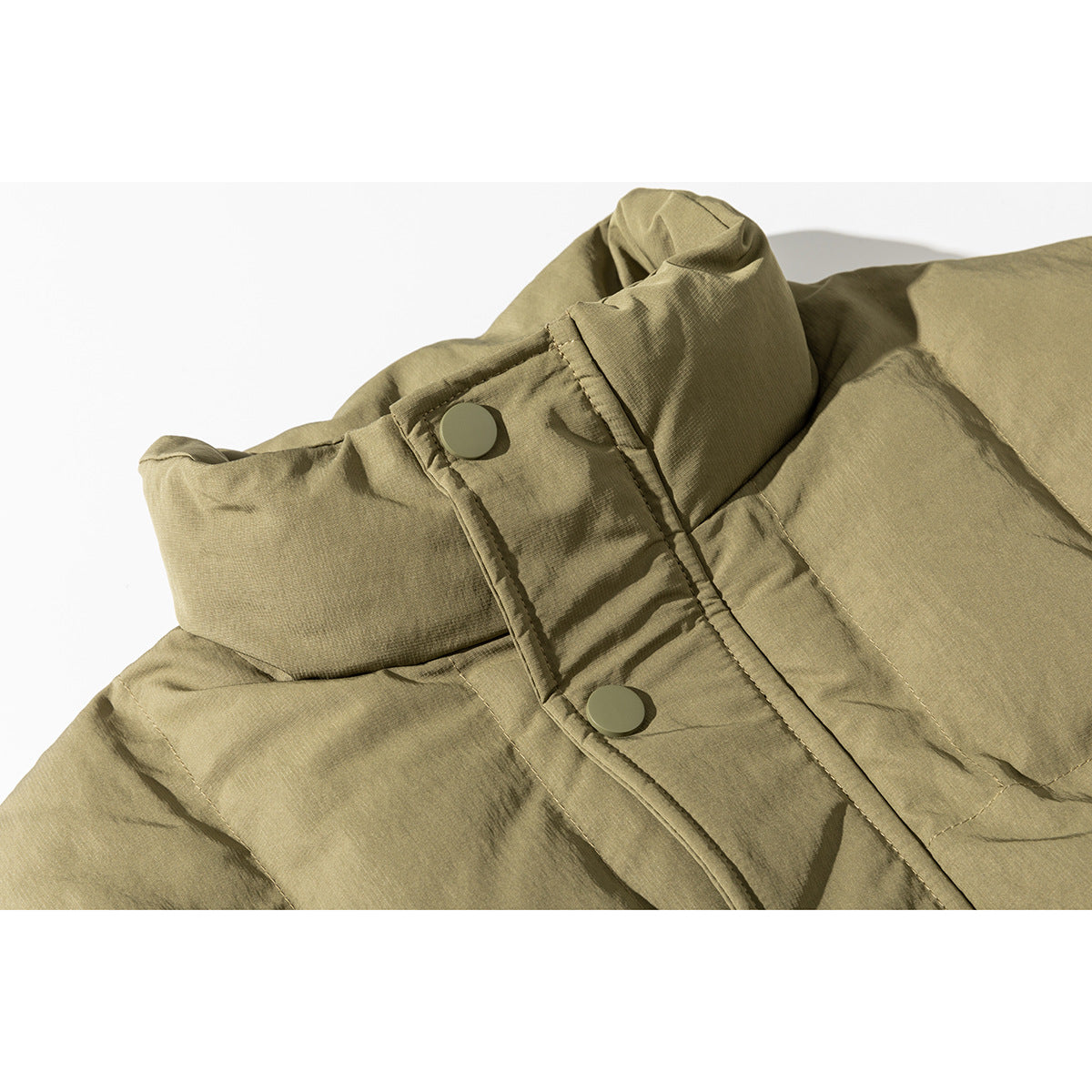 Close-up of an olive-khaki padded jacket collar and snap-button front placket.