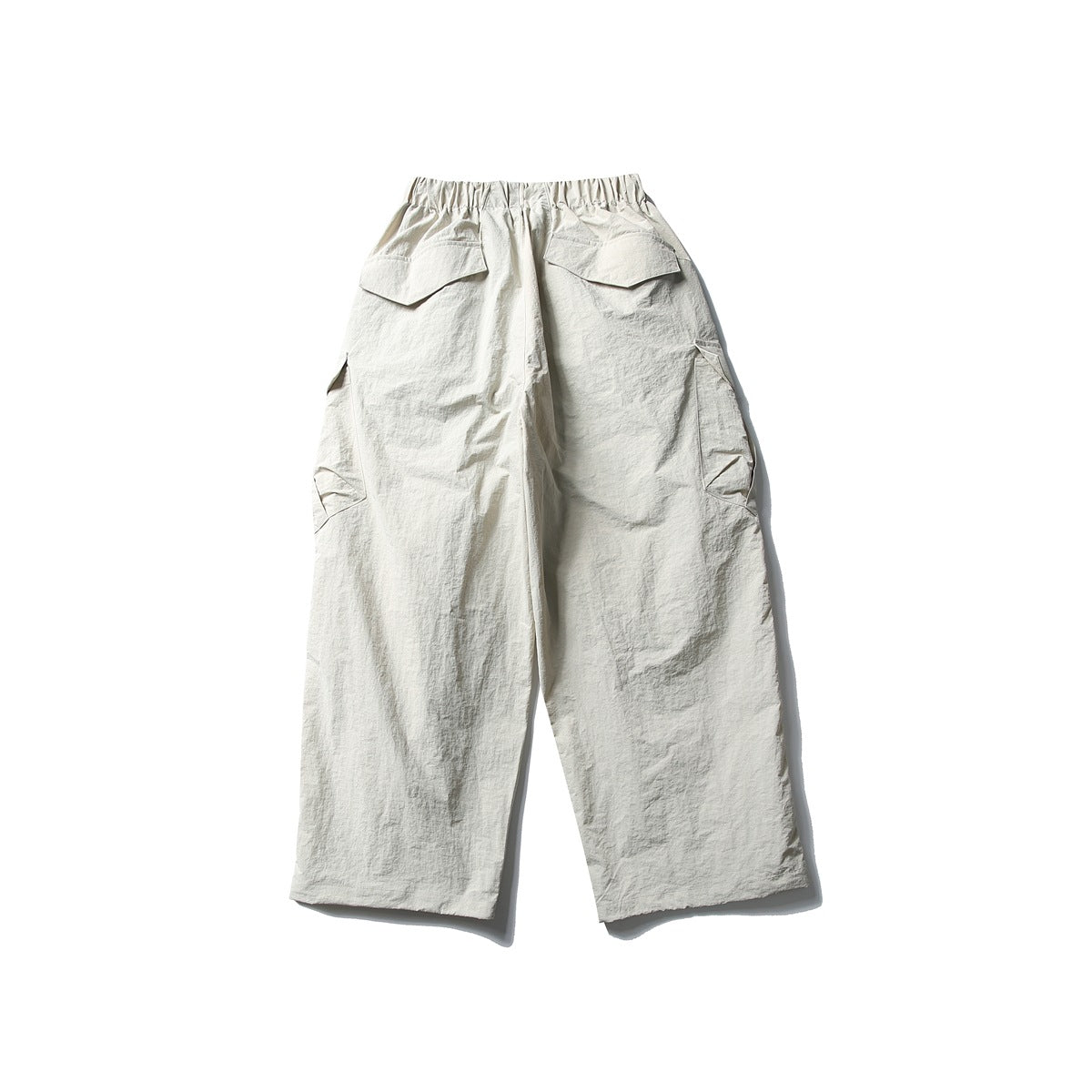 Back view of pale Paris Gray wide-leg cargo pants with elastic waistband, flap back pockets and side cargo pockets