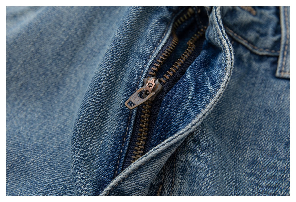 Close-up of the metal zipper and fly on blue jeans.