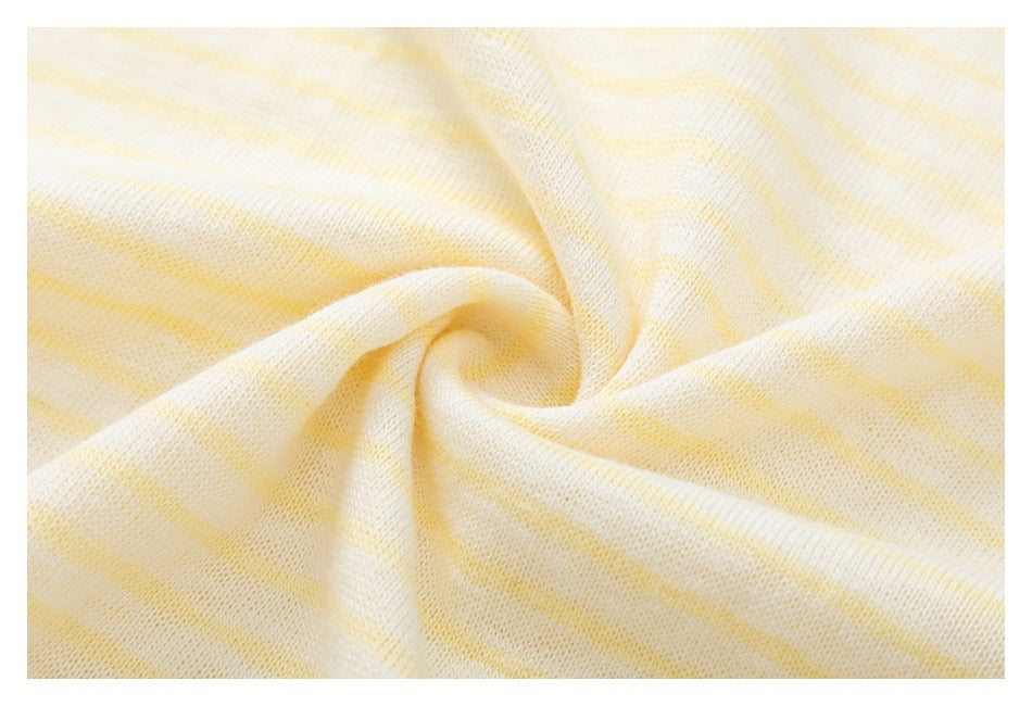 Close-up of softly twisted cream fabric with pale yellow stripes and visible knit texture.