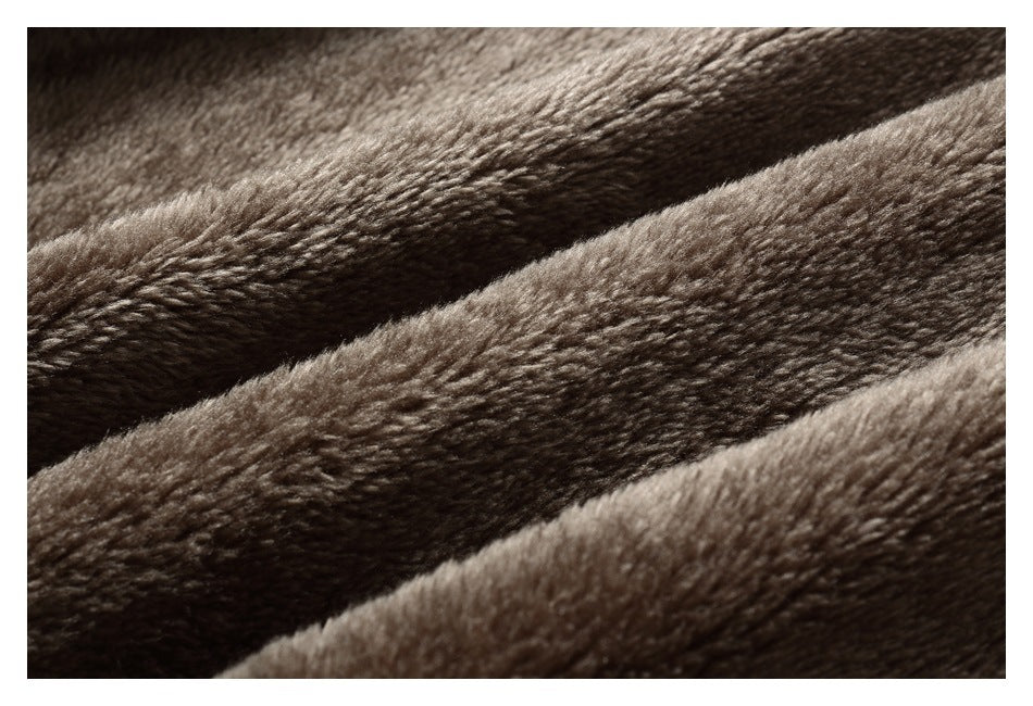 Close-up of the jacket’s plush taupe lining, arranged in soft folds.