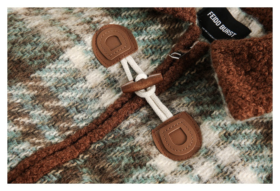 Close-up of cream cord and wooden toggle closures with brown tabs on the plaid jacket.