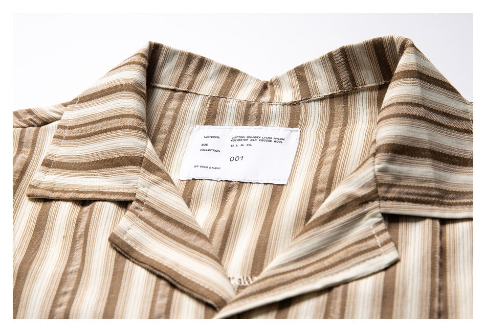 Close-up of the striped shirt’s open collar and interior label.