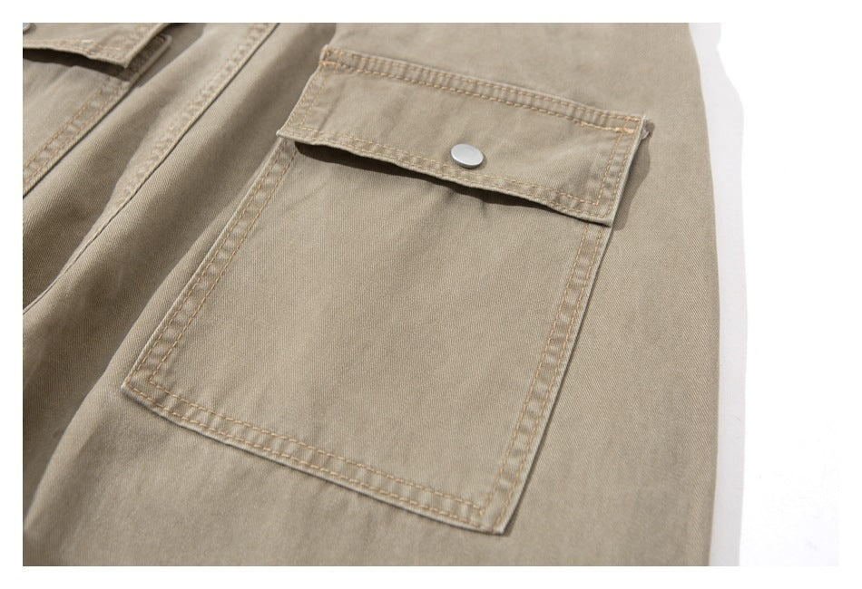 Close-up of a beige cargo pocket with a rectangular flap and silver snap button.