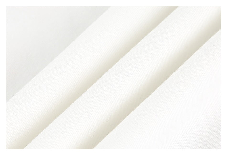 Close-up of white fabric folded to show its fine ribbed texture.