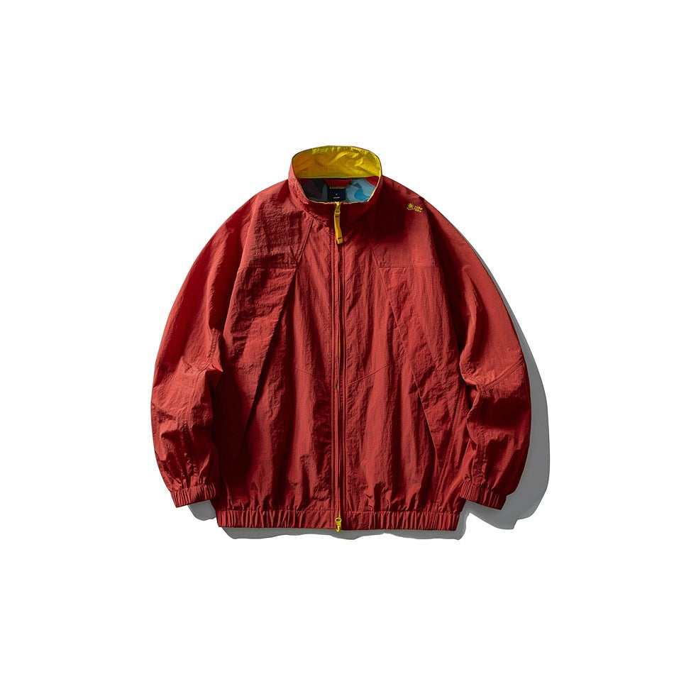 Berry red zip-up jacket with yellow inner collar, yellow zipper pull and elastic cuffs