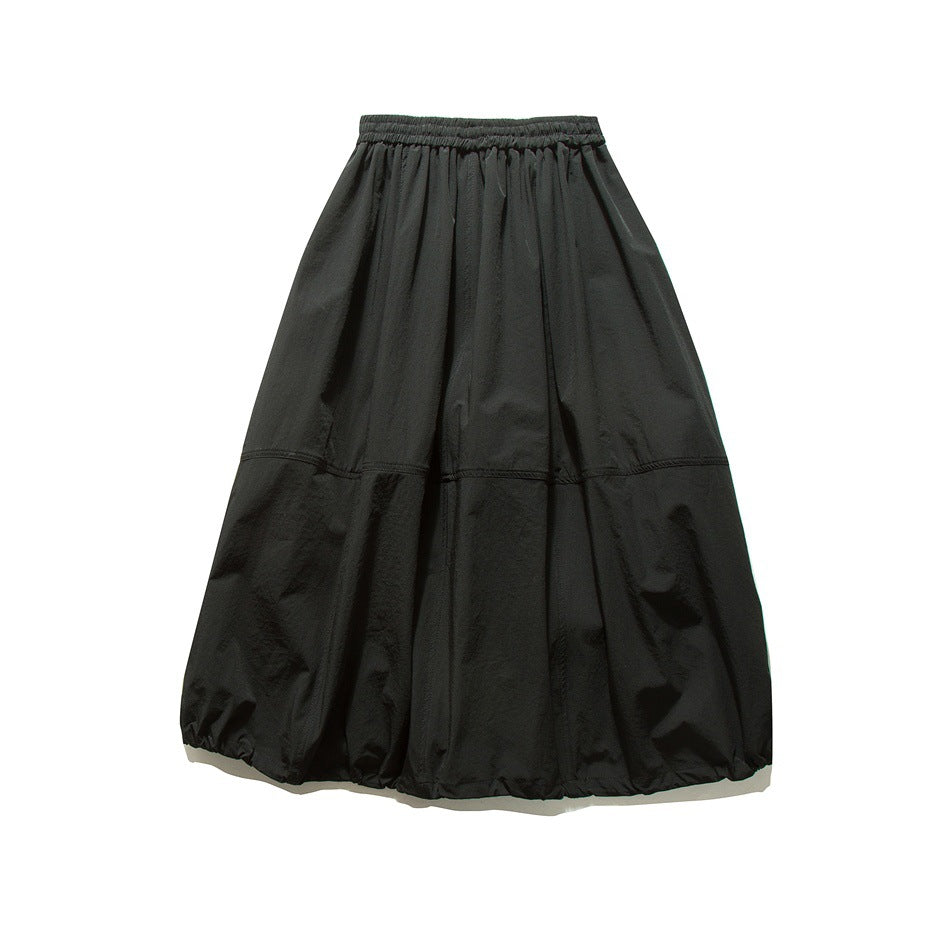 Back view of black long skirt flat lay with elastic waistband, horizontal seam and gathered hem