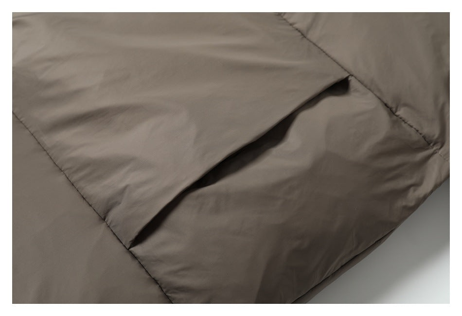 Close-up showing a slanted pocket opening on the taupe padded jacket.