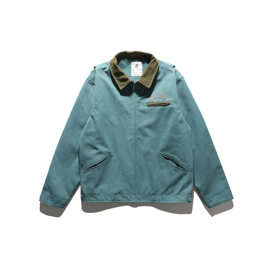 Teal blue zip-front jacket with olive collar, chest zip pocket and two angled front pockets
