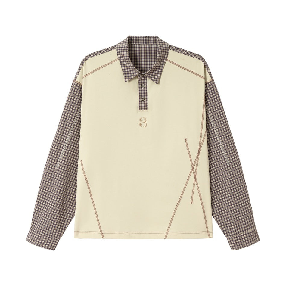 Apricot long-sleeve polo-style top with brown plaid collar and sleeves, contrast topstitching and embroidered 3