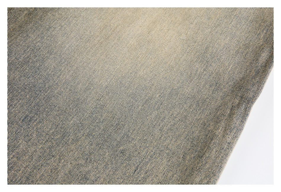 Close-up showing the mottled weave and faded finish of tan denim.