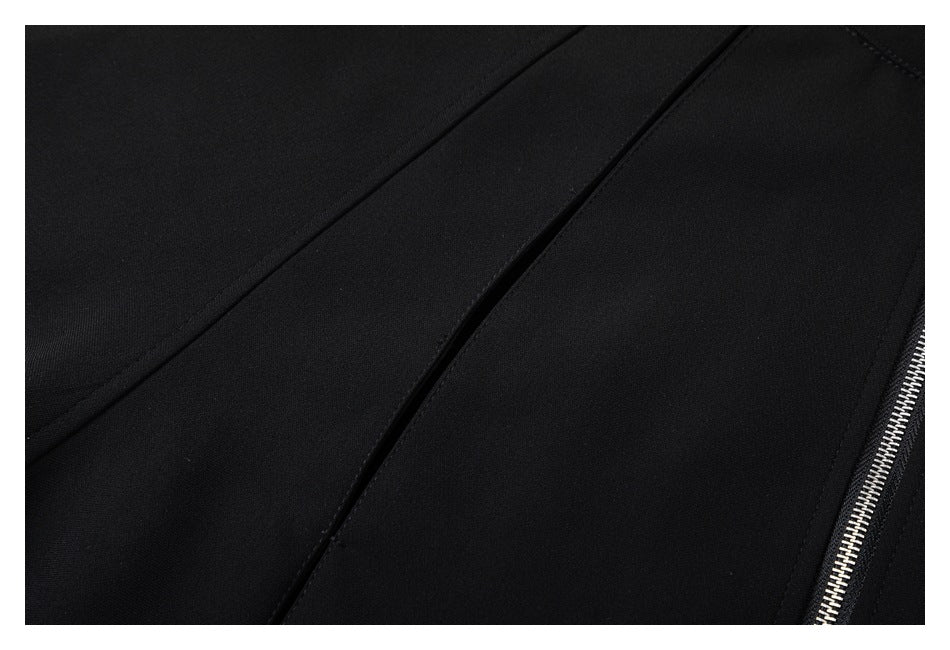 Close-up of black garment fabric with a diagonal seam and silver zipper teeth along the edge.