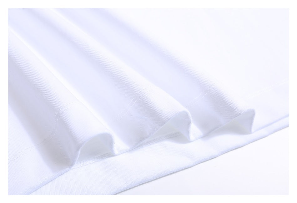 Close-up of white garment hem showing a folded edge and parallel rows of stitching.