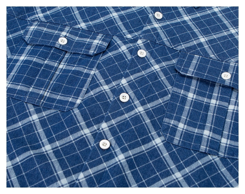 Close-up of the blue-and-white plaid shirt front with white buttons and chest pockets.