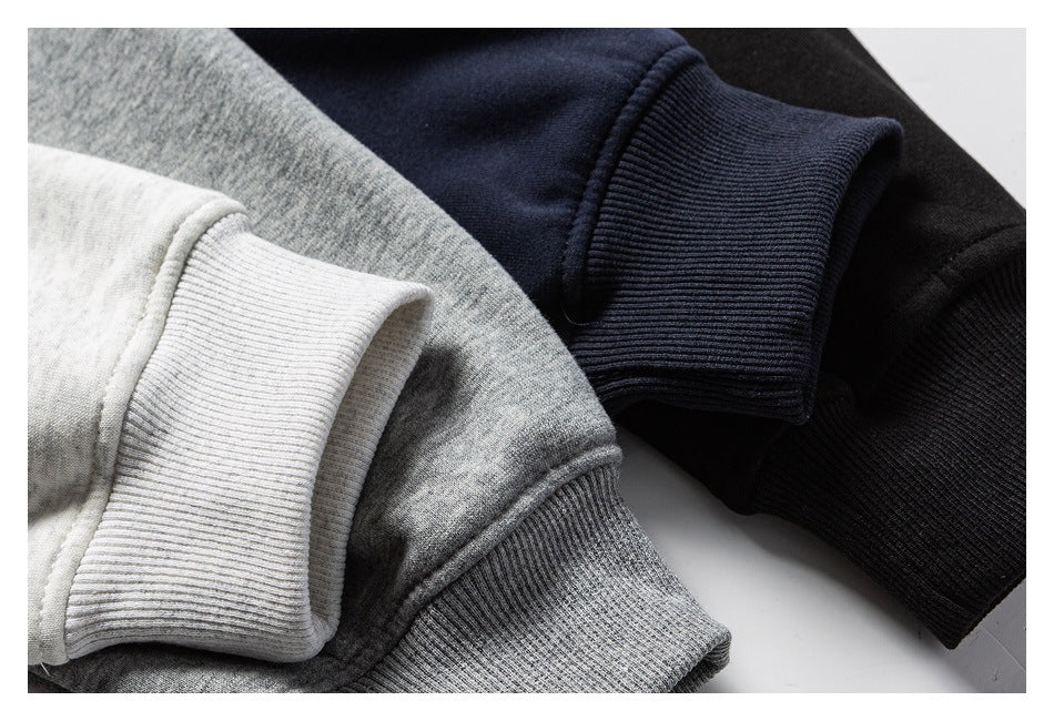Close-up of ribbed sweatshirt cuffs in light gray, heather gray, navy, and black.