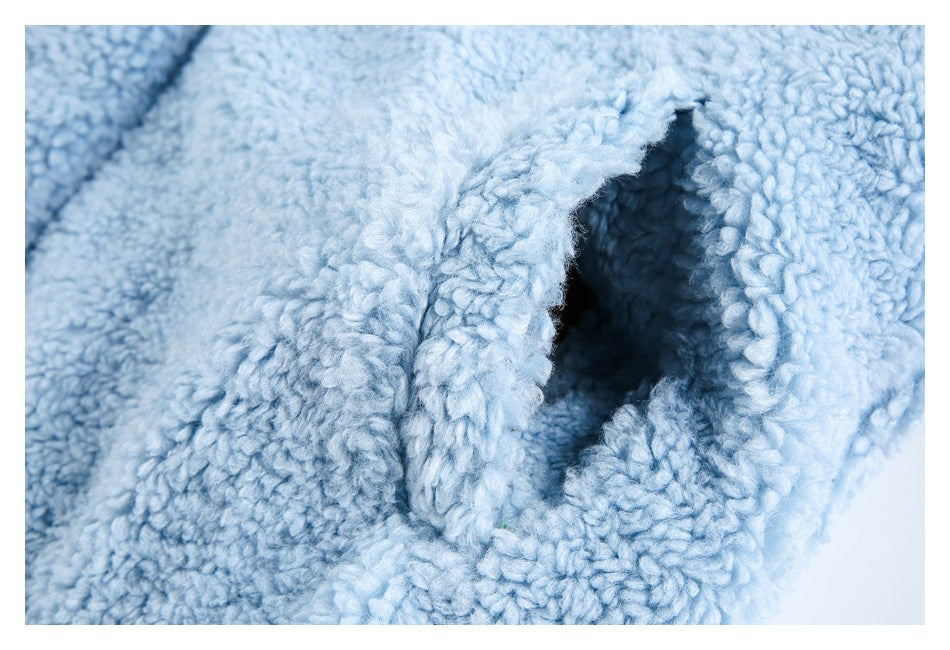 Close-up of an opening or pocket in pale blue plush fabric.