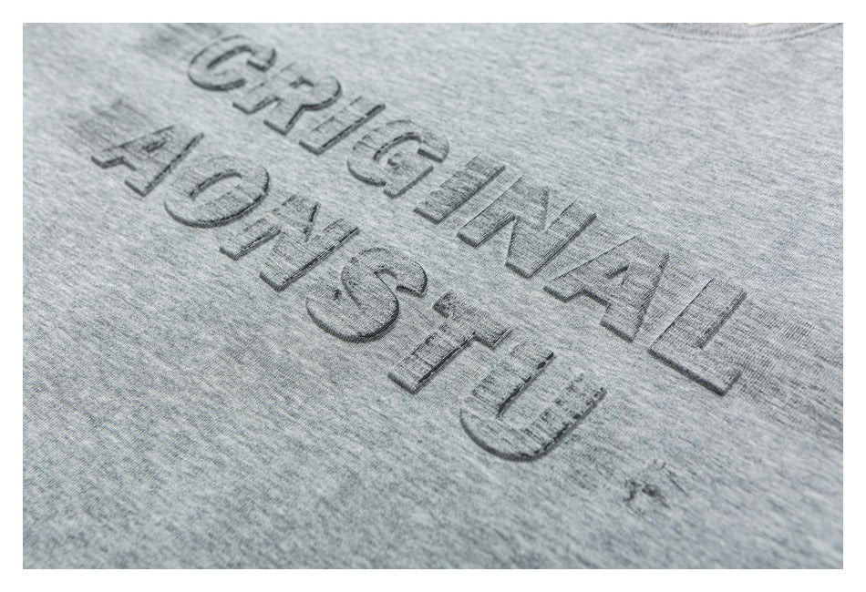 Close-up of raised dark lettering on heather gray fabric.
