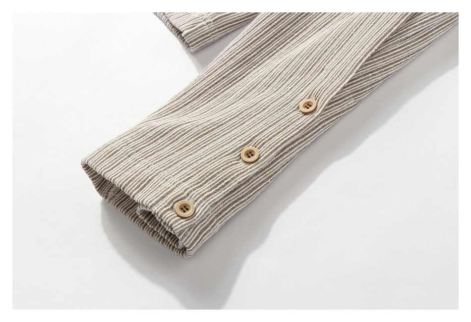 Close-up of a striped garment cuff with three tan buttons.