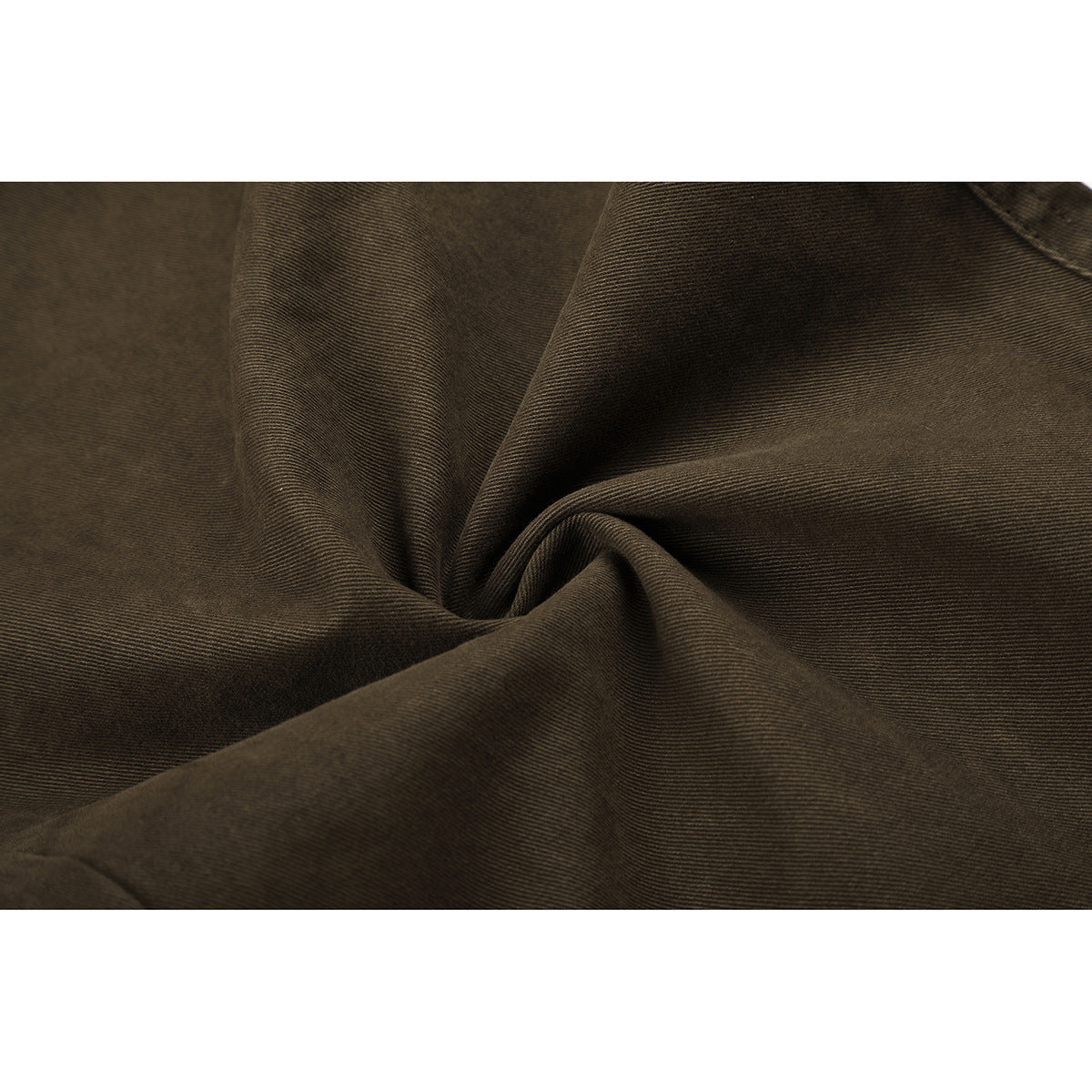 Close-up of olive-brown trouser fabric gathered to show its fine diagonal weave.