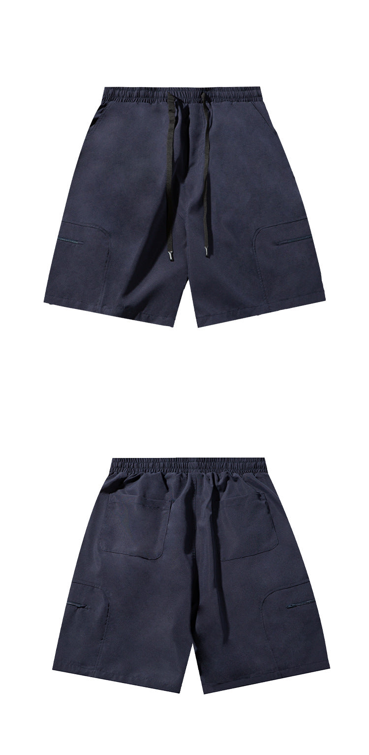 Navy drawstring shorts shown from the front and back, with side zip pockets and rear patch pockets.