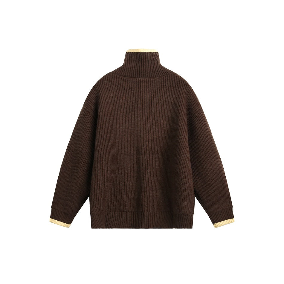 Back view of a brown ribbed sweater with a high collar and cream trim at the collar and cuffs.