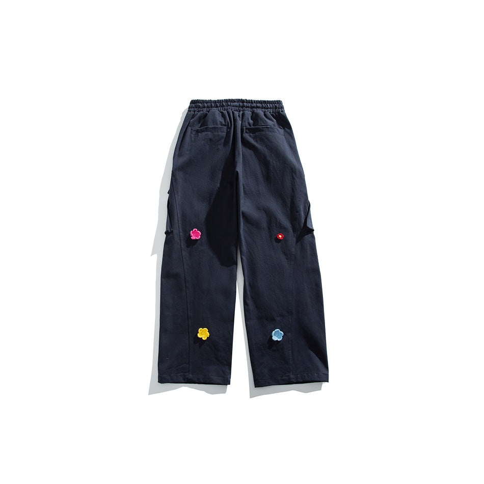 Navy wide-leg pants back view with elastic waist, back pockets and colorful flower appliqués