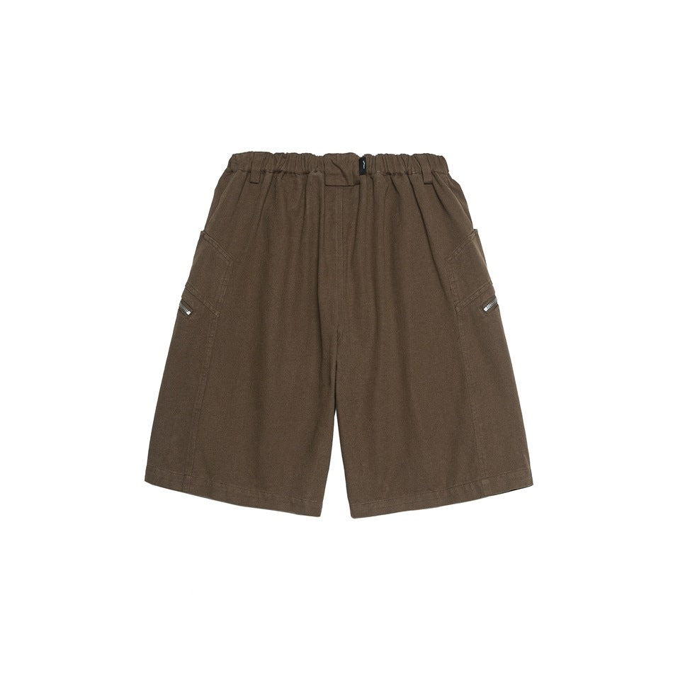 Back view of brown knee-length shorts with elastic waistband and side zipper pockets