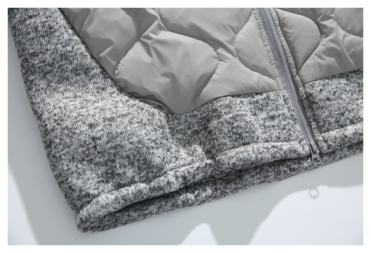 Close-up of the gray jacket's marled knit hem, quilted panel, and zipper seam.