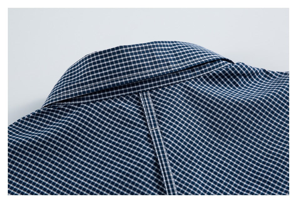 Close-up of the checked shirt collar and back yoke seam.
