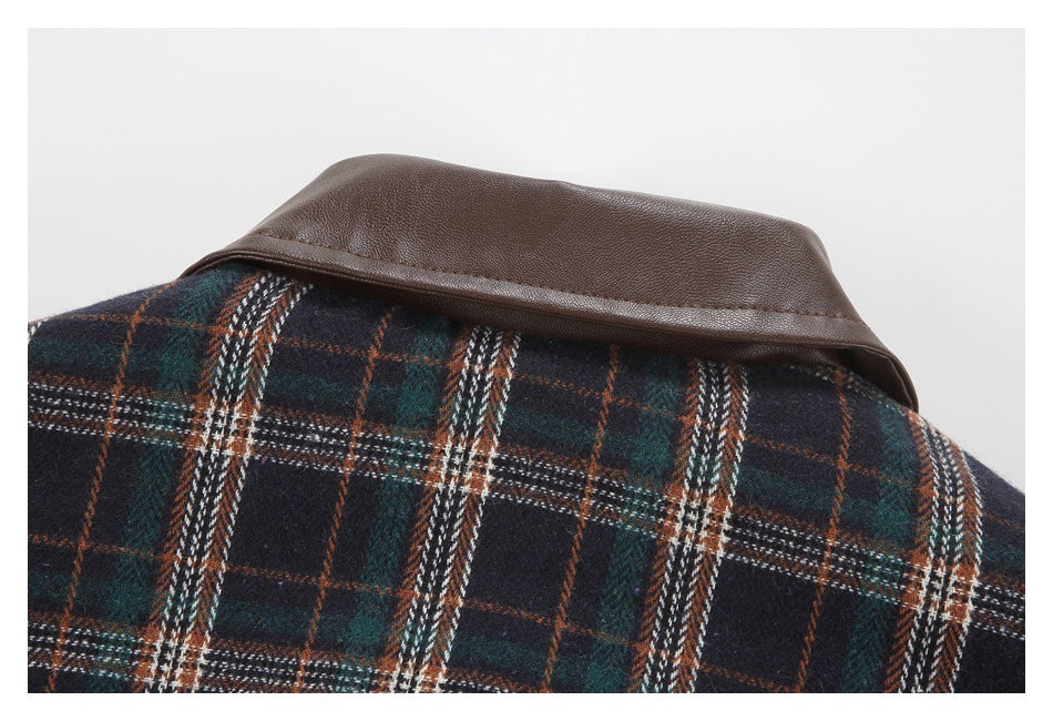 Close-up of a brown leather-look collar against a navy, green, rust, and white plaid garment.