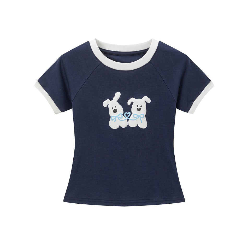 Navy short-sleeve cropped tee with white neck and cuff trim and a raised two-dog graphic with blue bows on the front