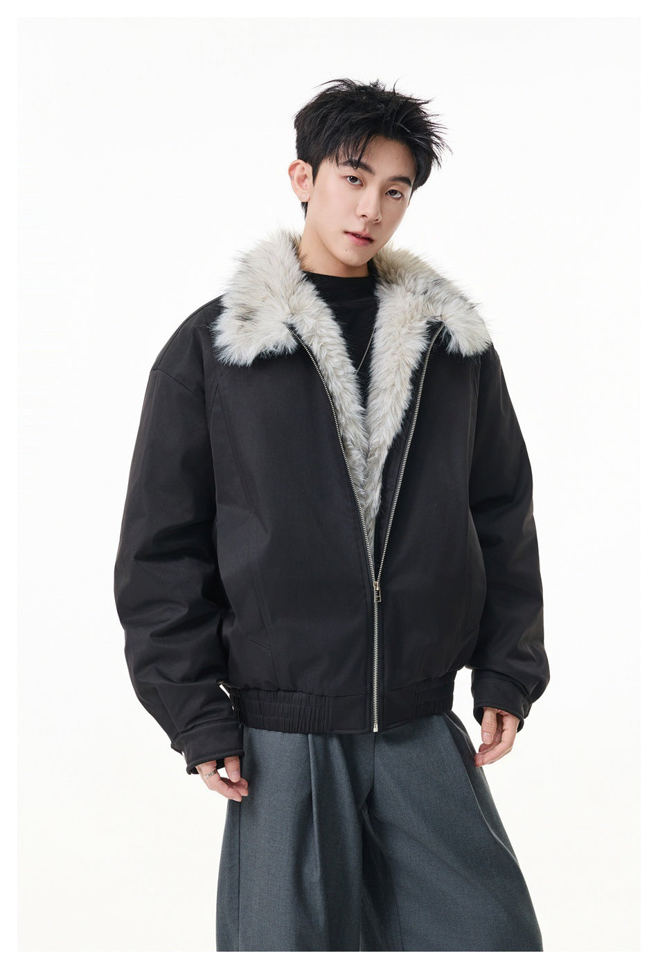Model wearing a black zip-front jacket with a wide light gray fur collar and gathered hem.