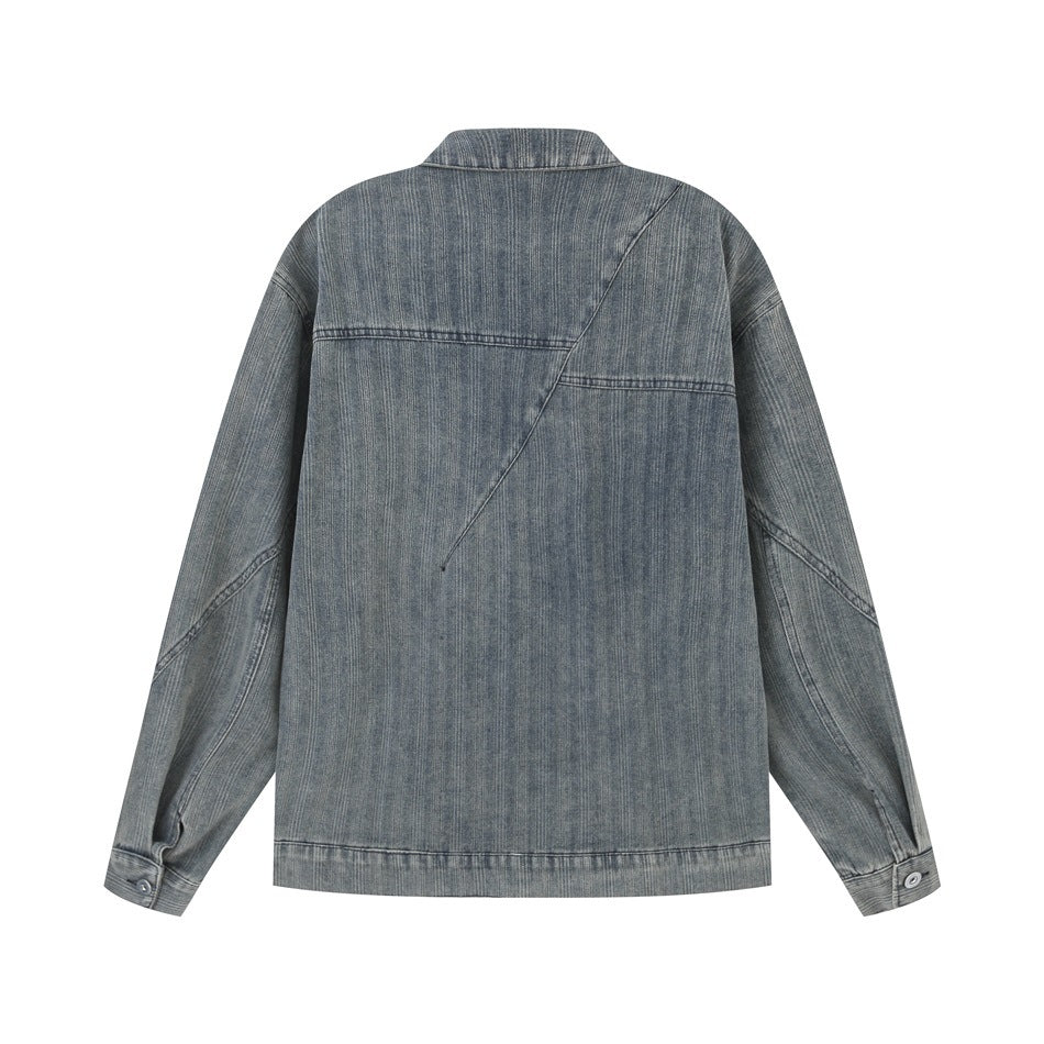 Back view of a washed blue-gray denim jacket with an angular seam across the upper back.