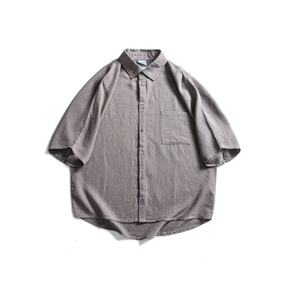 Gray short-sleeve button-front shirt with collar and chest pocket, flat lay front view