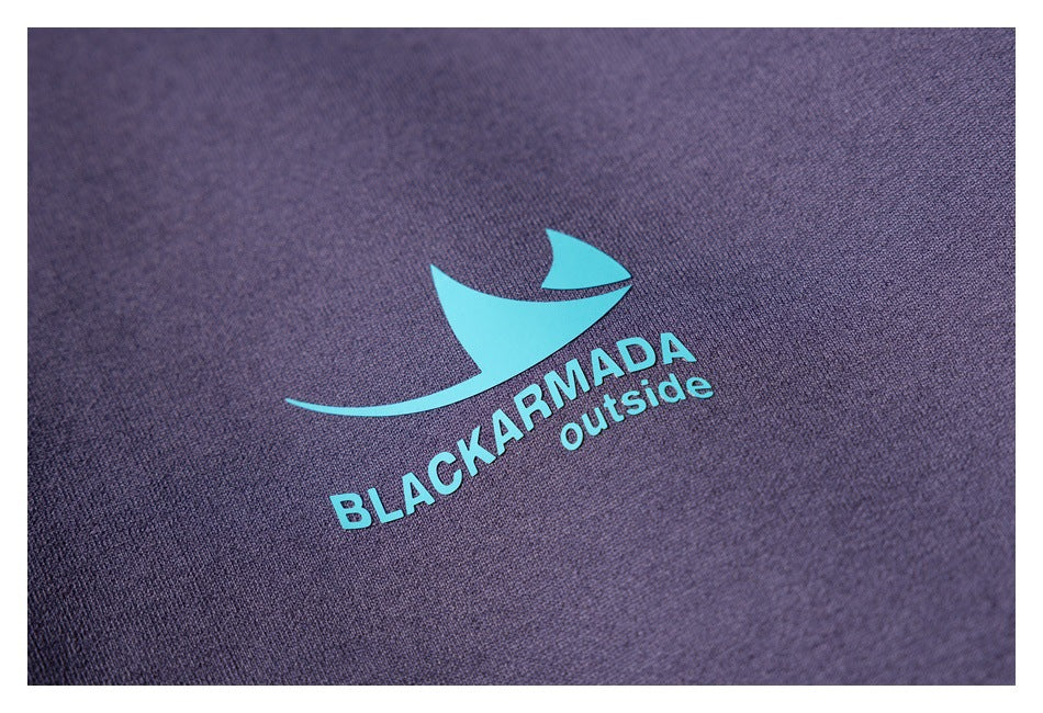 Close-up of a teal sail graphic and “BLACKARMADA outside” print on purple fabric.