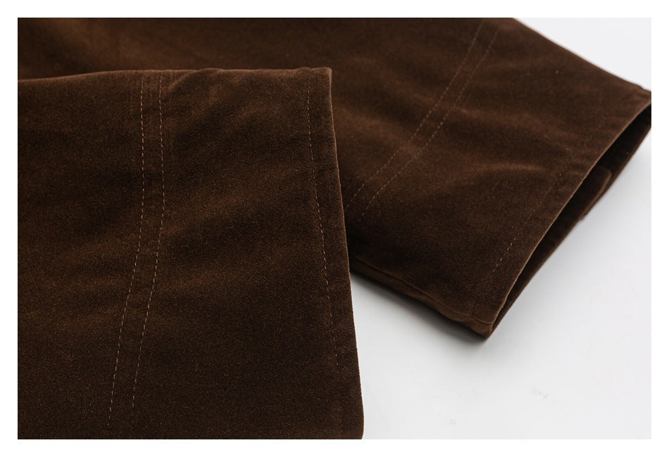 Close-up of a brown garment sleeve with stitched seam details and a folded cuff.