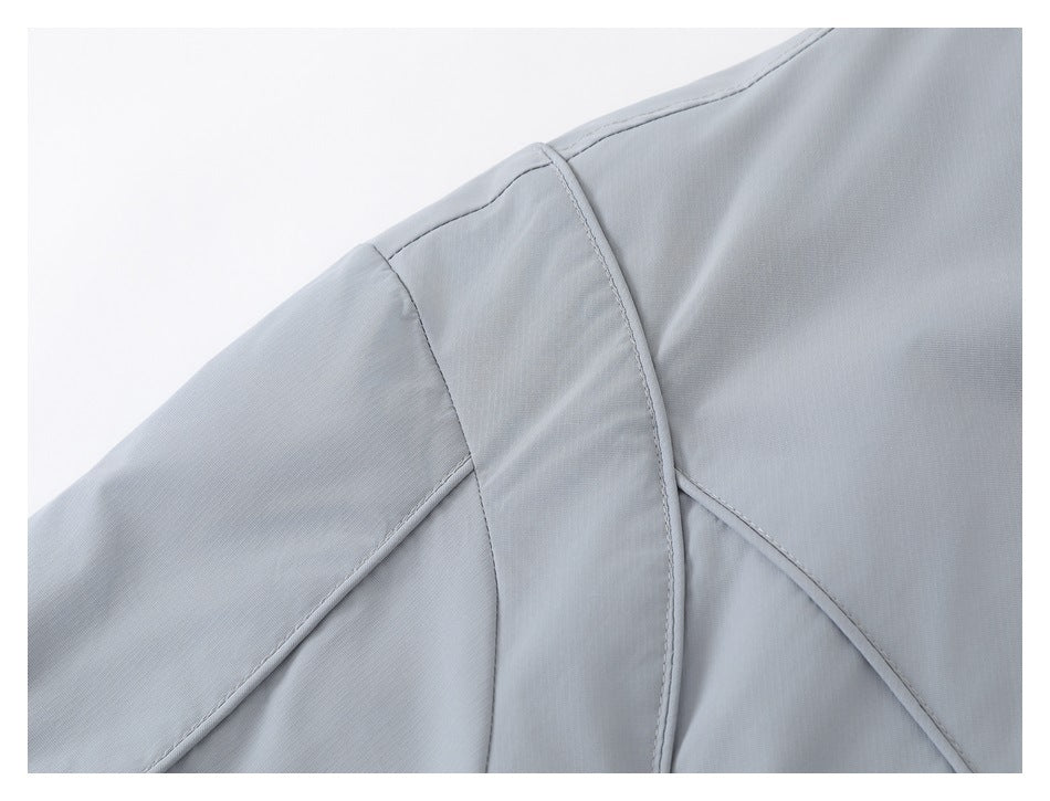 Close-up of the jacket's shoulder and sleeve seams in light gray-blue fabric.