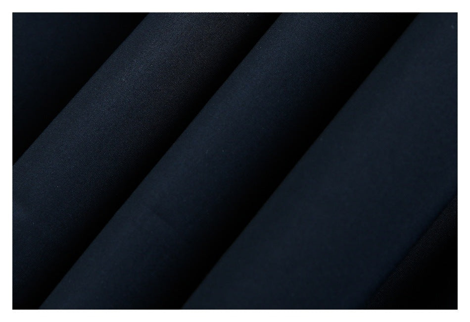 Macro view of dark navy fabric showing its fine surface texture.