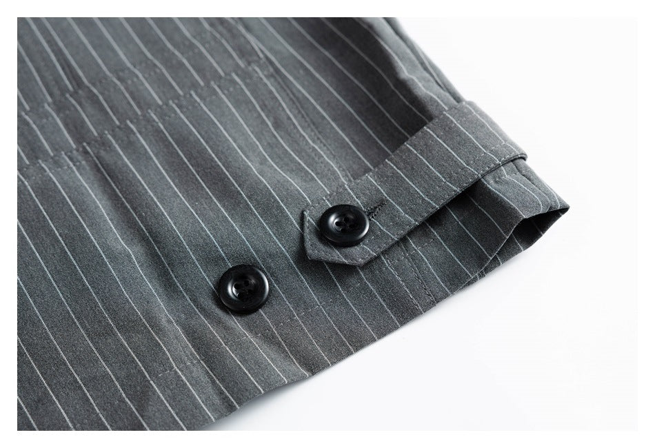 Close-up of a charcoal pinstripe sleeve cuff with two black buttons and a button tab.