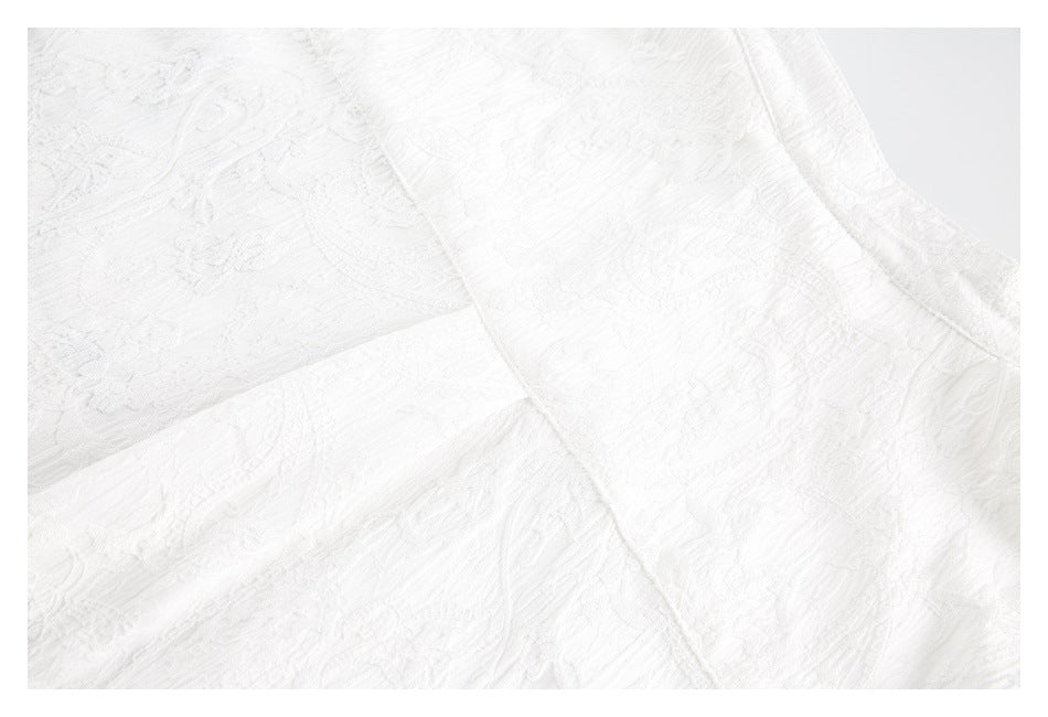 Close-up of overlapping white garment panels with raised texture and visible seam lines.