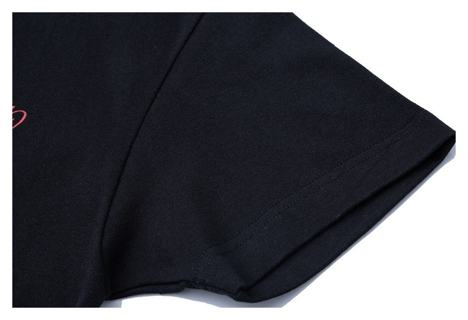 Close-up of the short sleeve and stitched hem of a black shirt.