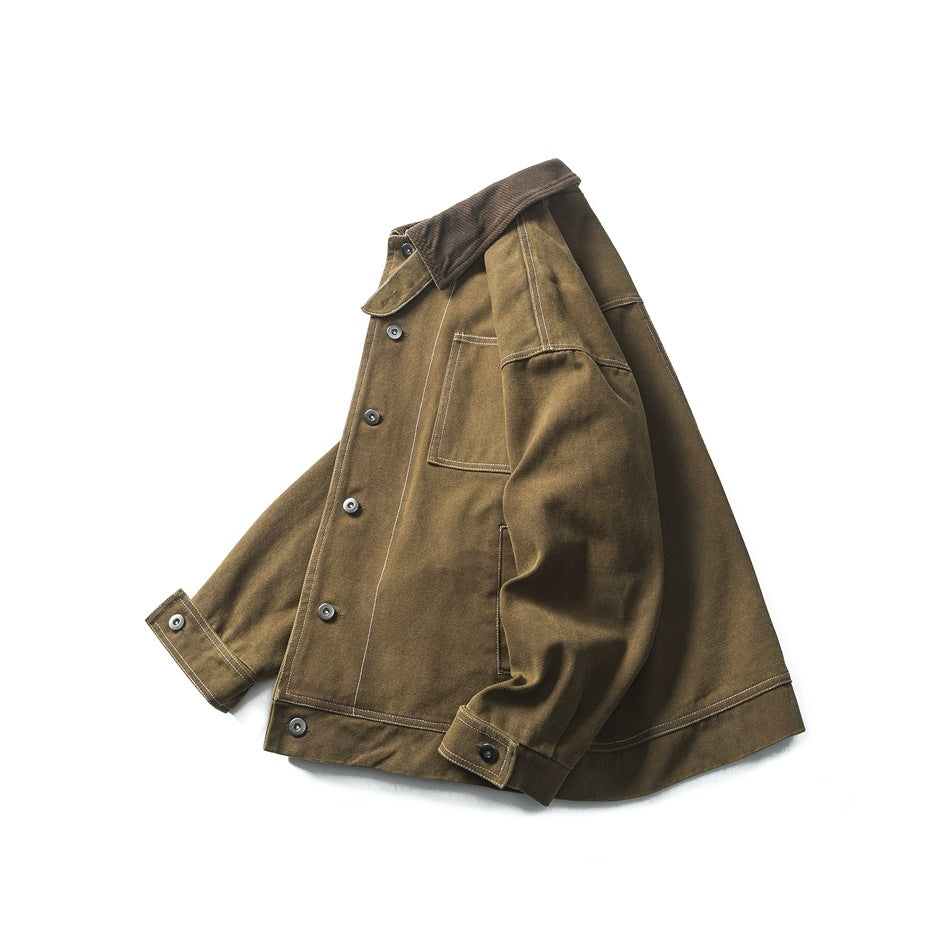 Brown work jacket shown at an angle, with a dark corduroy collar, front buttons, chest pocket, and contrast stitching.