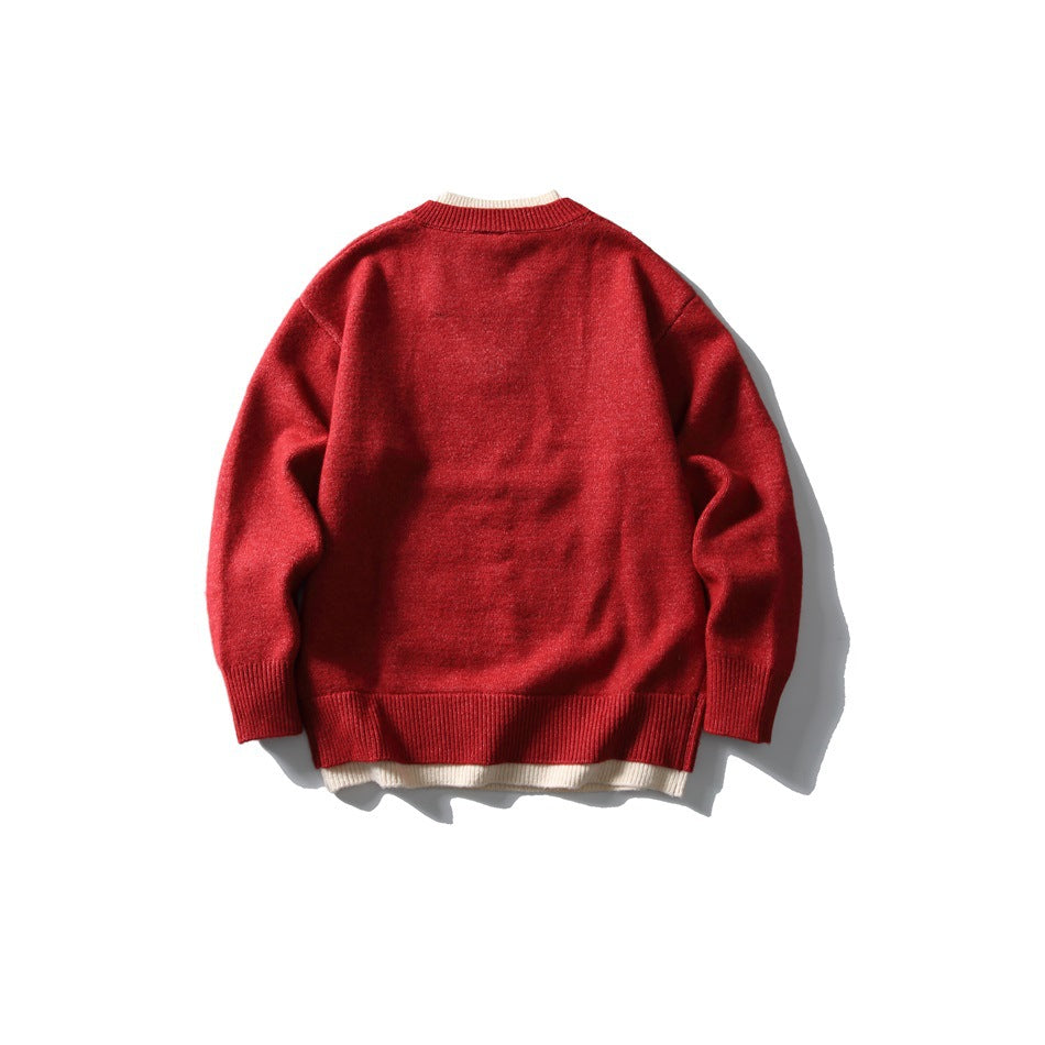 Back view of red knit sweater with crew neckline and cream layered trim at collar and hem