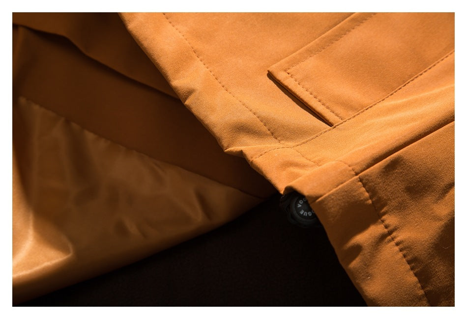 Close-up of the orange jacket's hem and black cord adjuster.